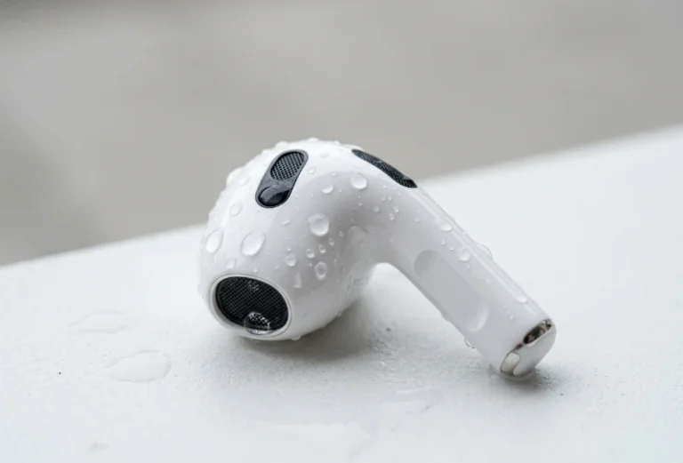 water eject airpods with visible water droplets on speaker